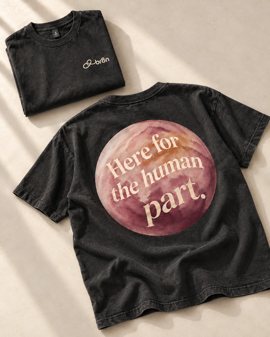 Front and back of a BR8N shirt with signature and flowing orb artwork.