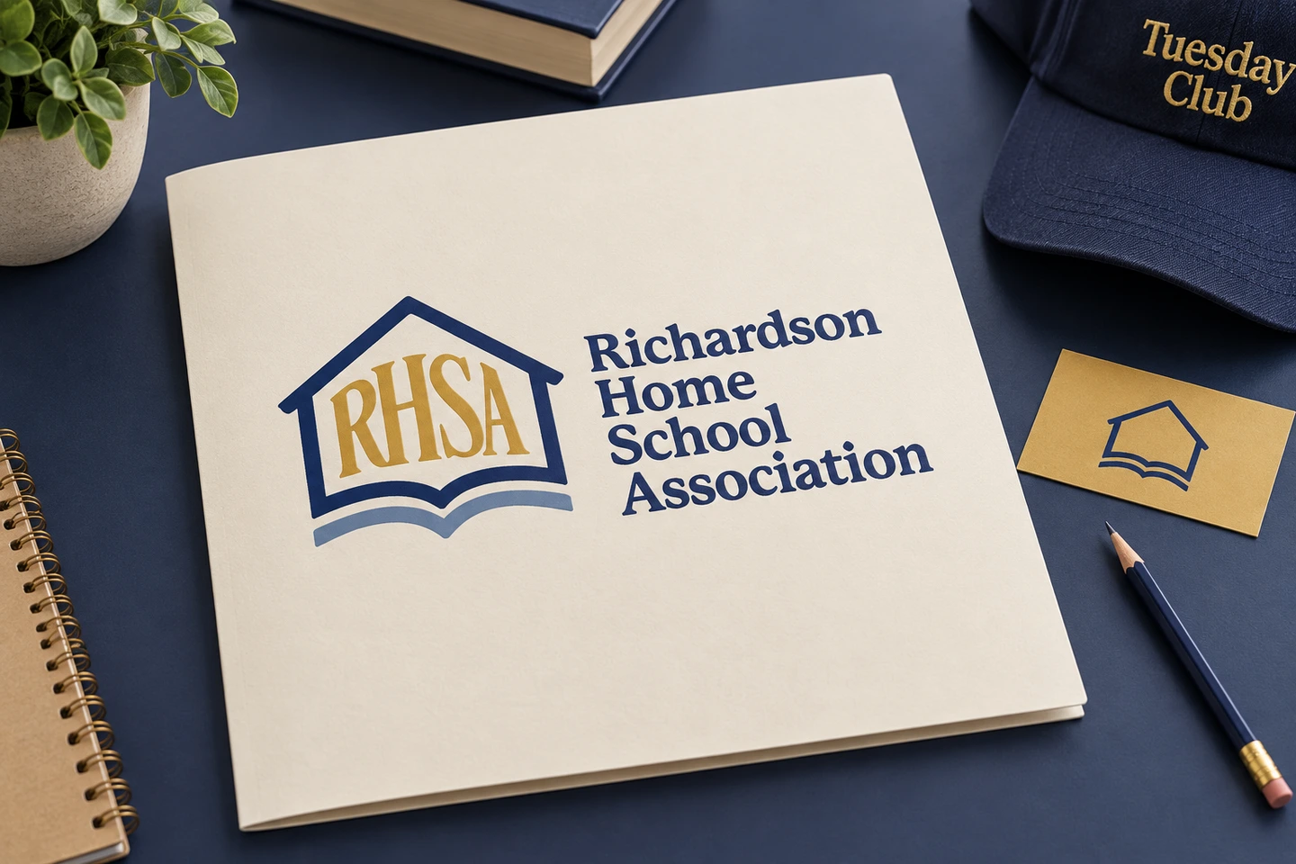 RHSA navy and gold identity on a folder, card and Tuesday Club cap.