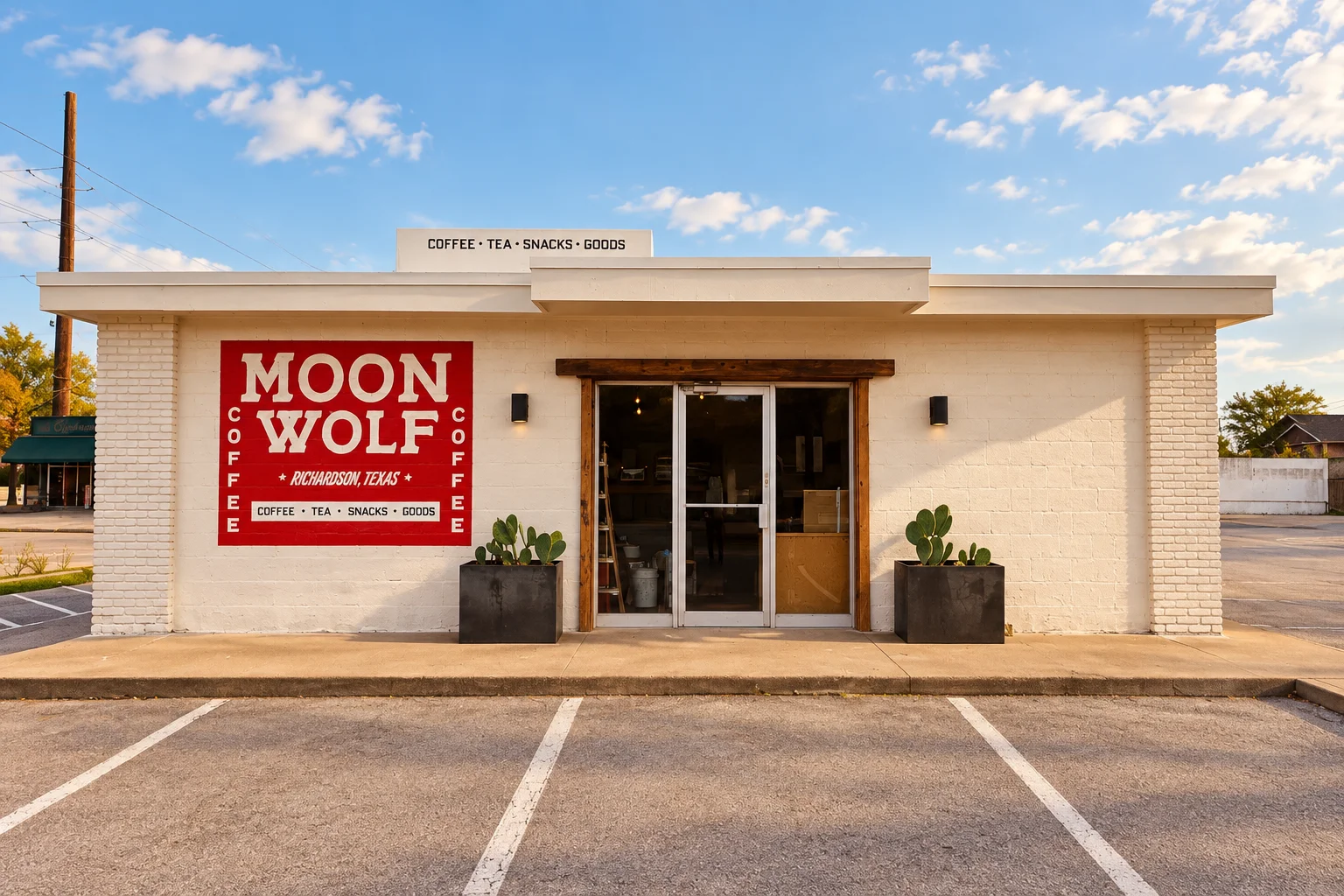 Moon Wolf Provisions storefront with its red painted sign in afternoon light.